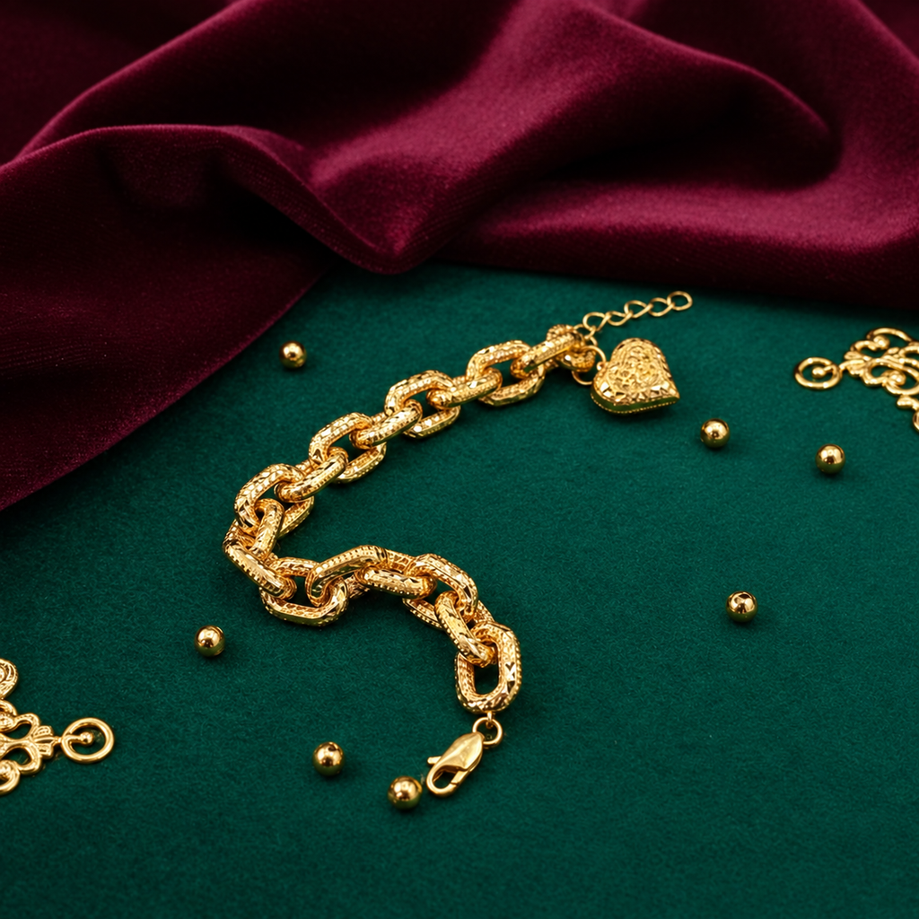 Gold reverse of the 916 gold Regal Link Heart Charm Bracelet arranged on green fabric