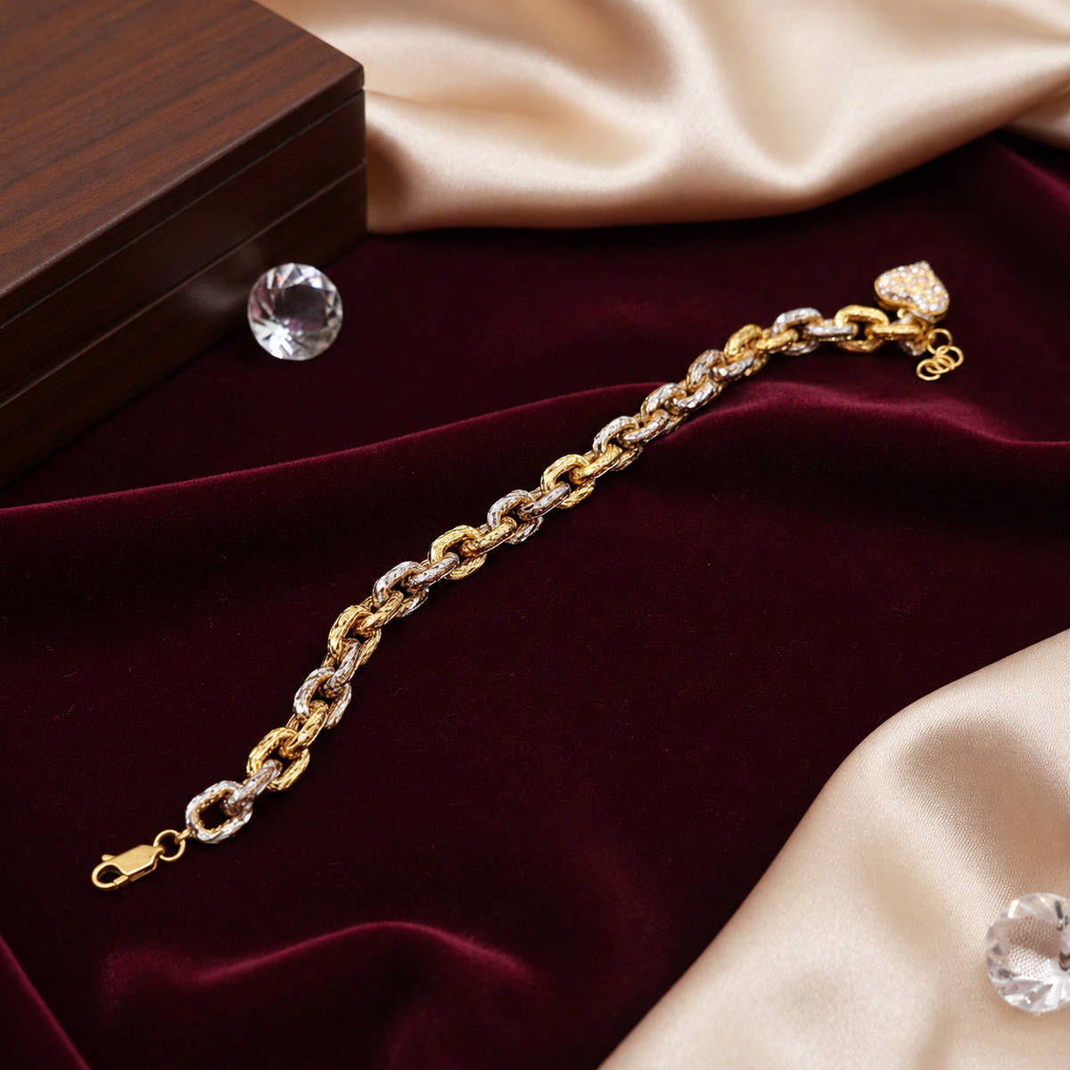 Full front view of the two-tone 916 gold Regal Link Heart Charm Bracelet extended on burgundy velvet