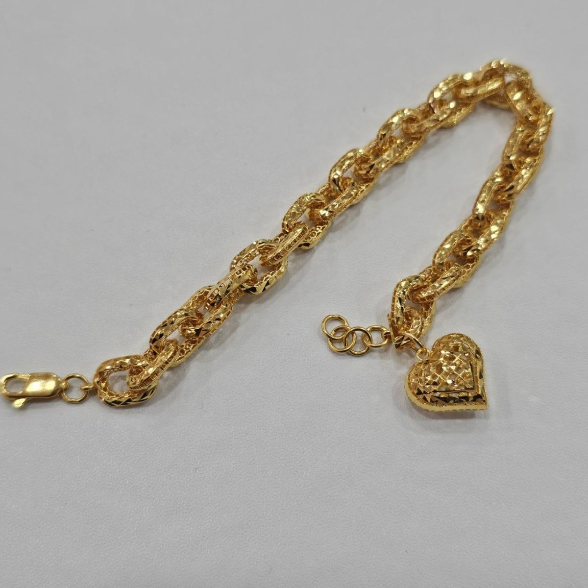 Original reverse view of the 916 gold Regal Link Bracelet showing gold heart charm and extension rings