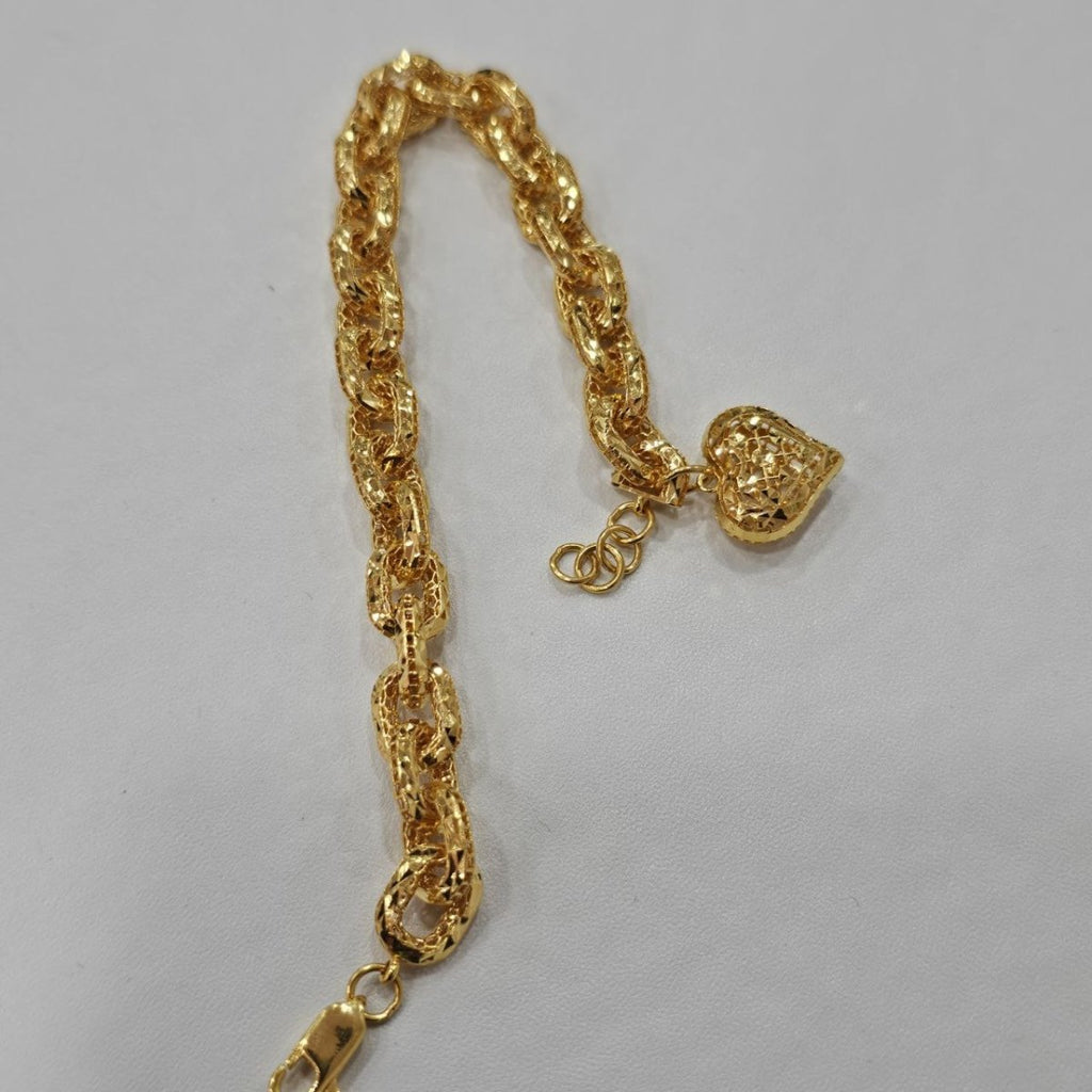 Original reverse length view of the 22K gold Regal Link Heart Charm Bracelet on a plain pale surface