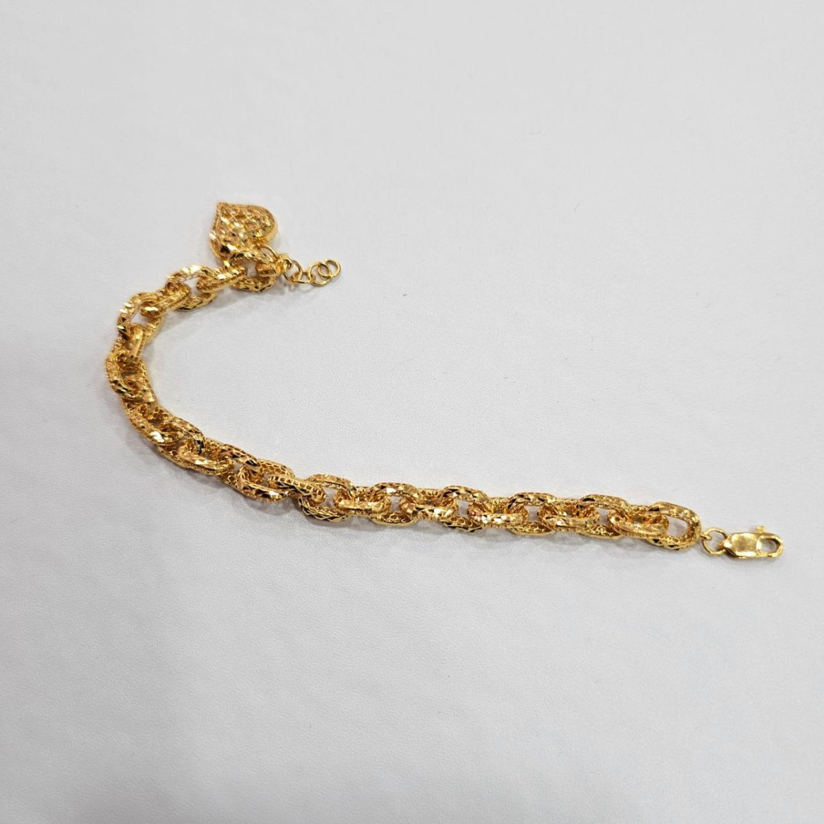 Original curved reverse view of the 916 gold Regal Link Bracelet with gold heart charm and lobster clasp
