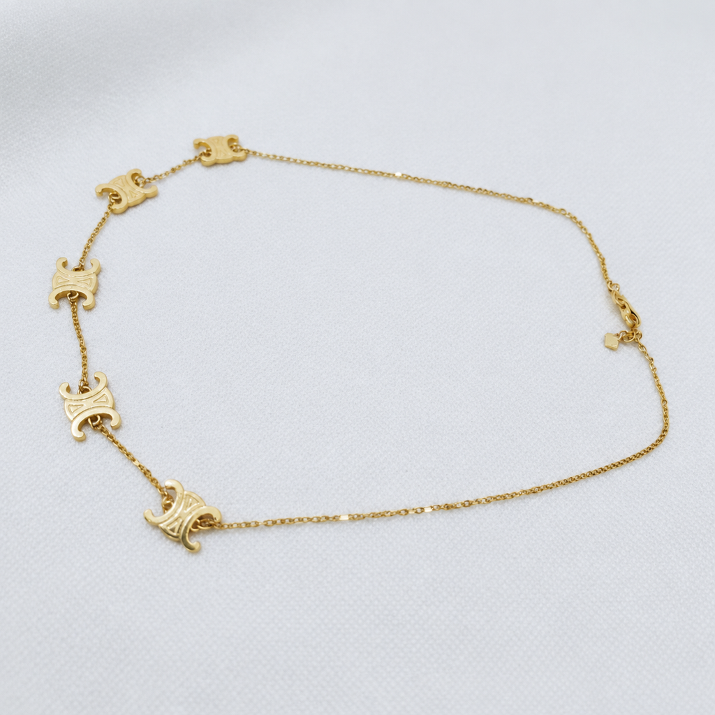 Full necklace view of the 22K gold Adjustable Scroll Link Chain with five decorative motifs and extension chain