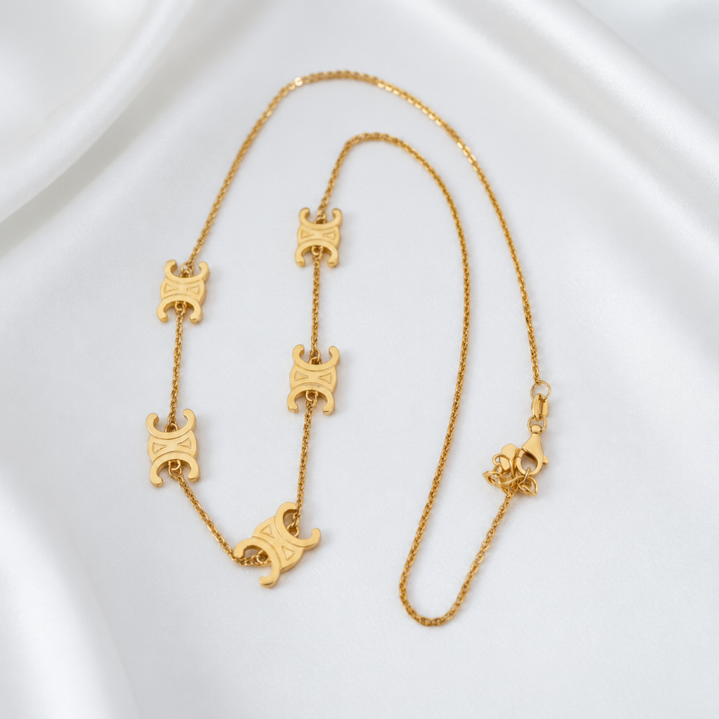 916 gold Scroll Link Chain arranged lengthwise to show the engraved scroll motifs, fine links and lobster clasp