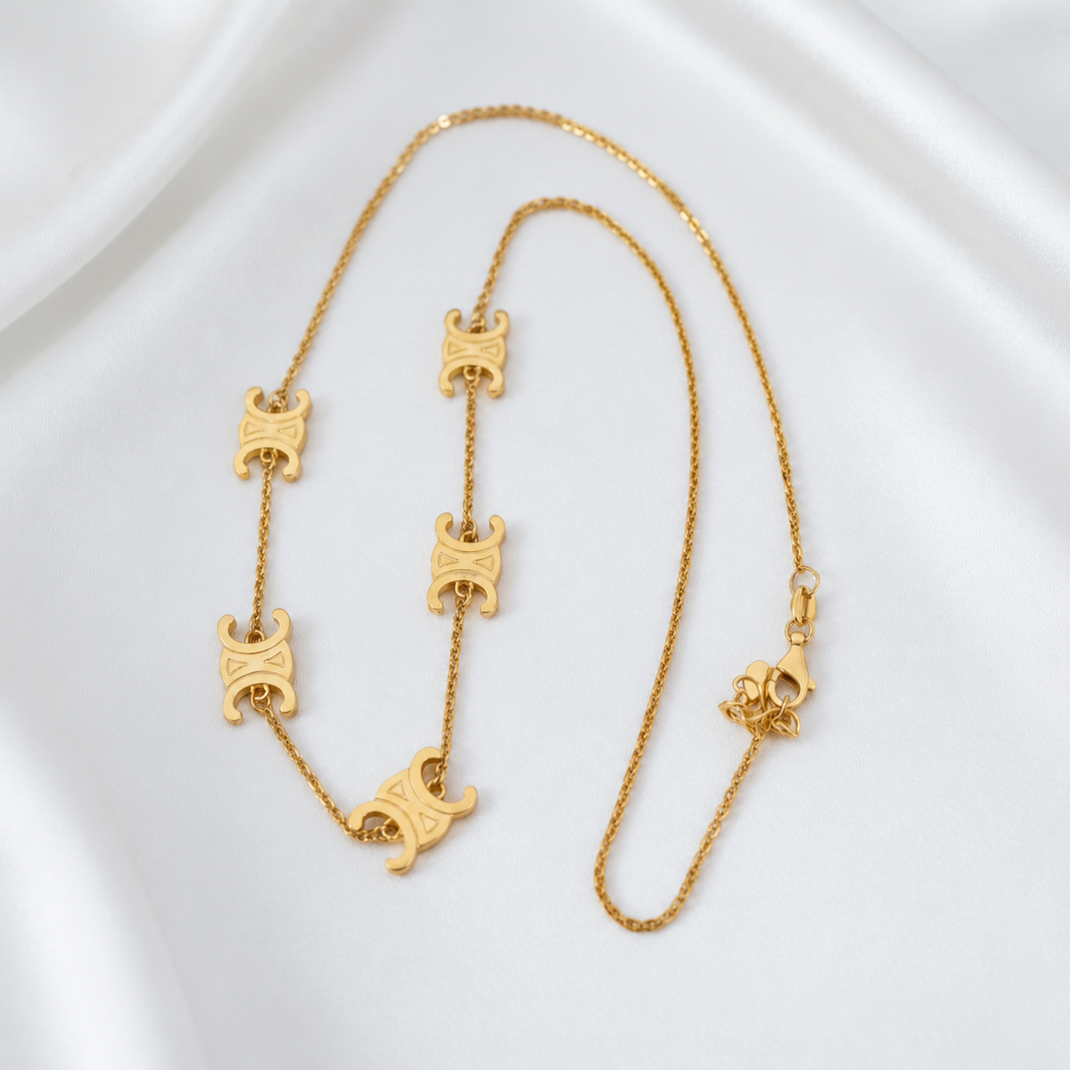 916 gold Scroll Link Chain arranged lengthwise to show the engraved scroll motifs, fine links and lobster clasp