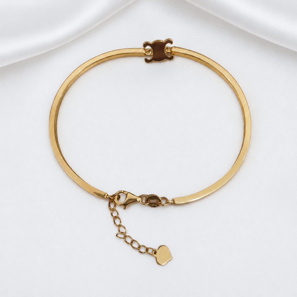 Front view of the 916 gold adjustable Scroll Motif Bangle with a polished band, clasp and extension chain