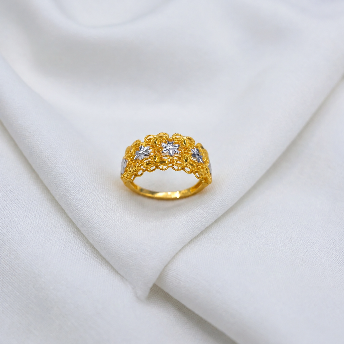 Front view of the 916 gold Serenity Petal ring showing contrasting flower motifs, beaded borders and scalloped openwork