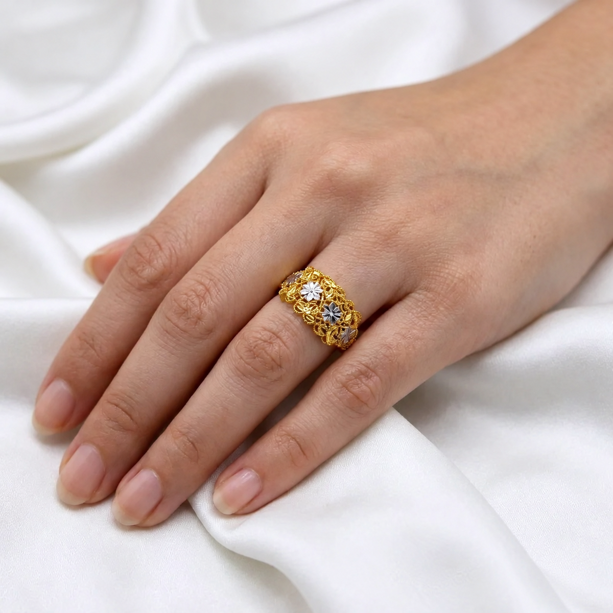 916 gold Serenity Petal two-tone floral ring worn on a hand, shown as a styling reference