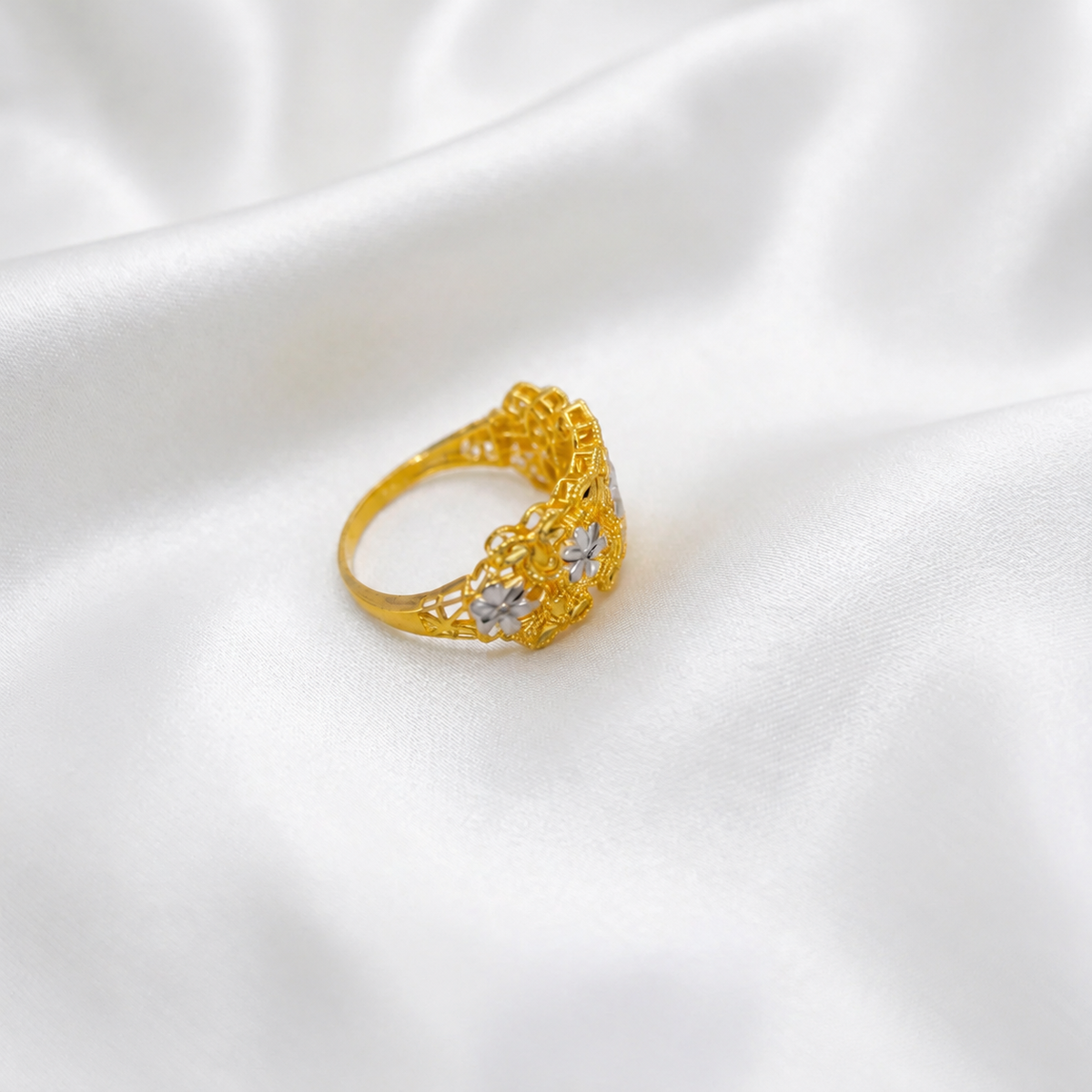 Side view of the 916 gold Serenity Petal ring showing the floral openwork shoulders and narrower polished band