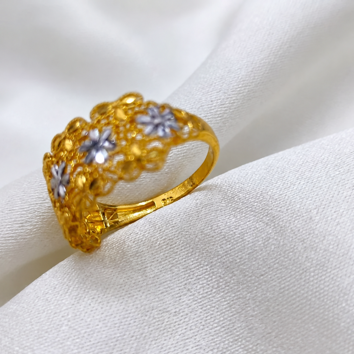 Close-up of the inner band and hallmark area of the 916 gold Serenity Petal two-tone floral ring