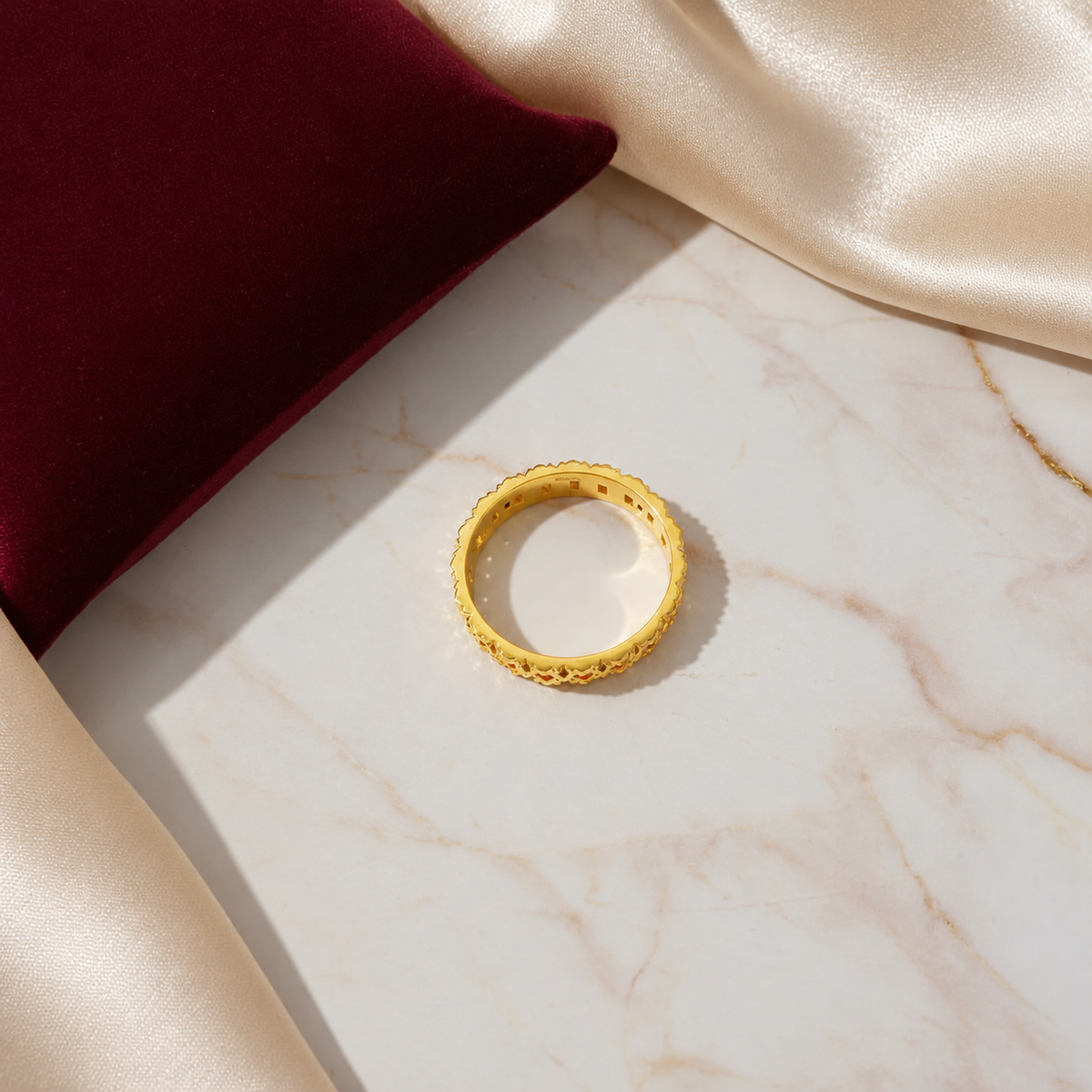 Overhead view of the 916 gold Slim Keeper ring showing its inner band and openwork edge on marble