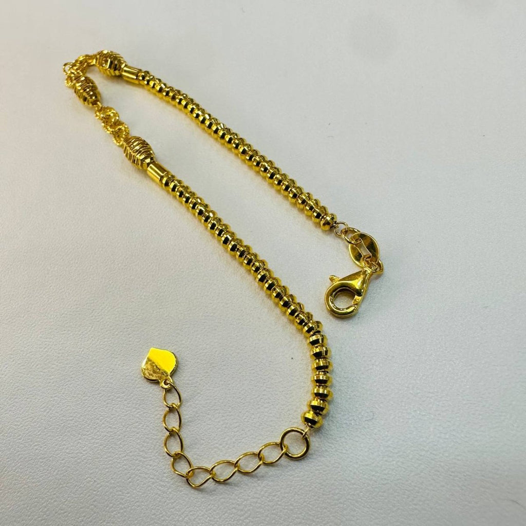 Guild Bullion 22K / 916 gold triple oval bracelet with extension chain and lobster clasp on cream fabric
