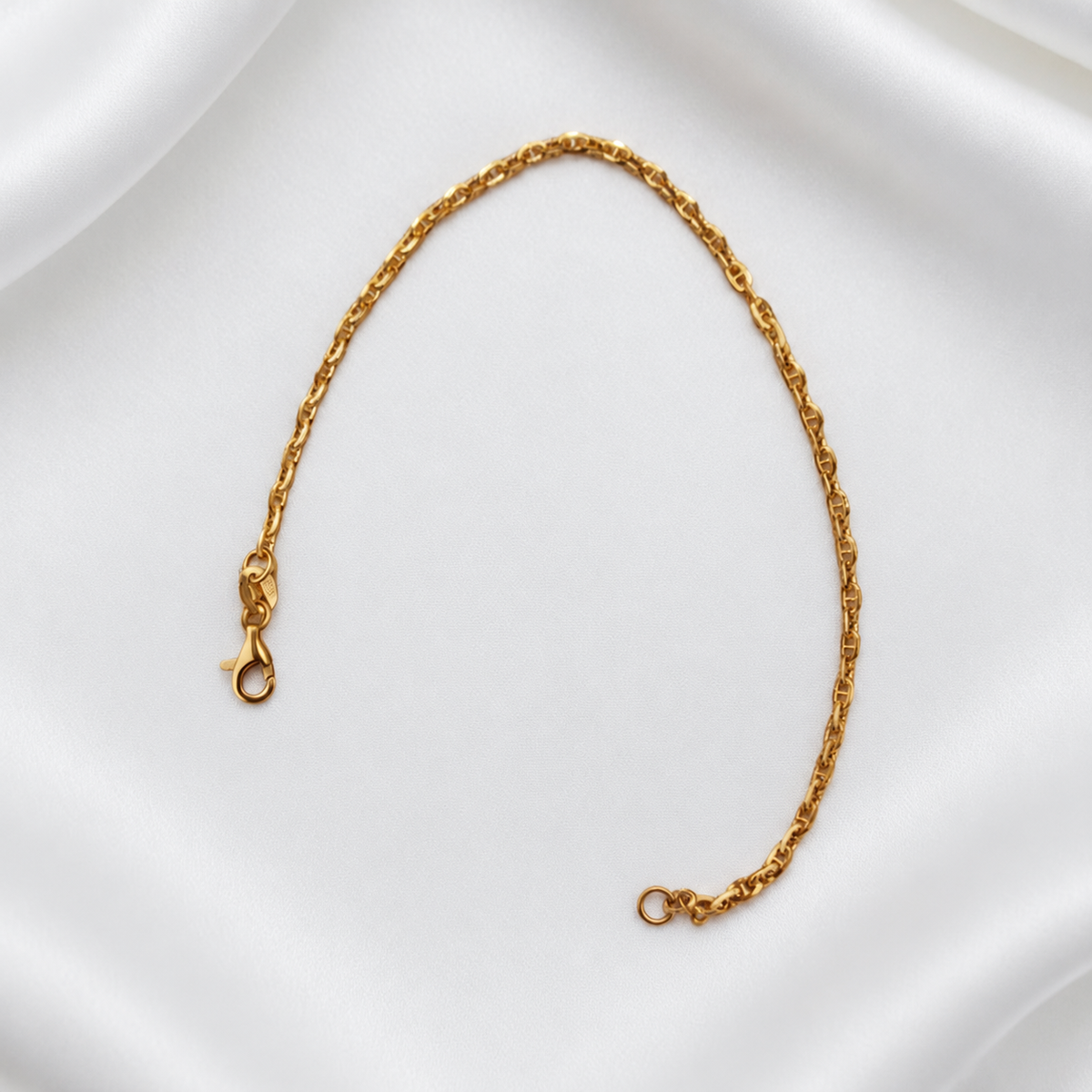 Guild Bullion 22K gold Twisted Link Bracelet in an oval arrangement on white satin with open clasp