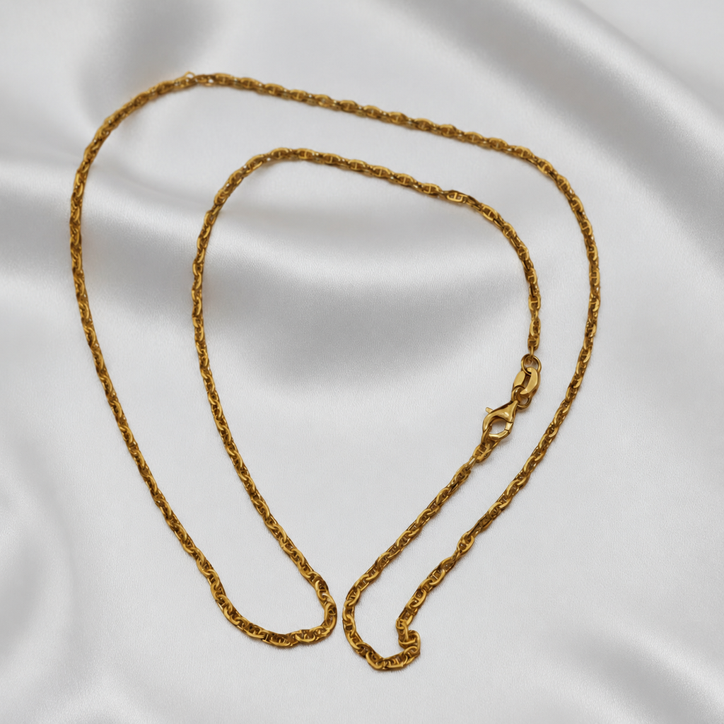 Guild Bullion 916 gold twisted link necklace arranged in a coil on white satin with clasp visible