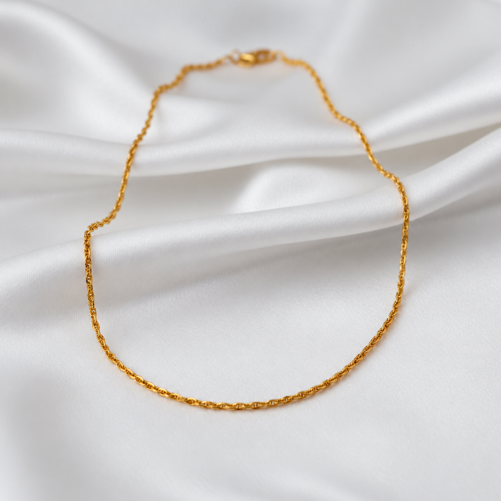 Guild Bullion 22K gold twisted link necklace in a full oval arrangement on white satin