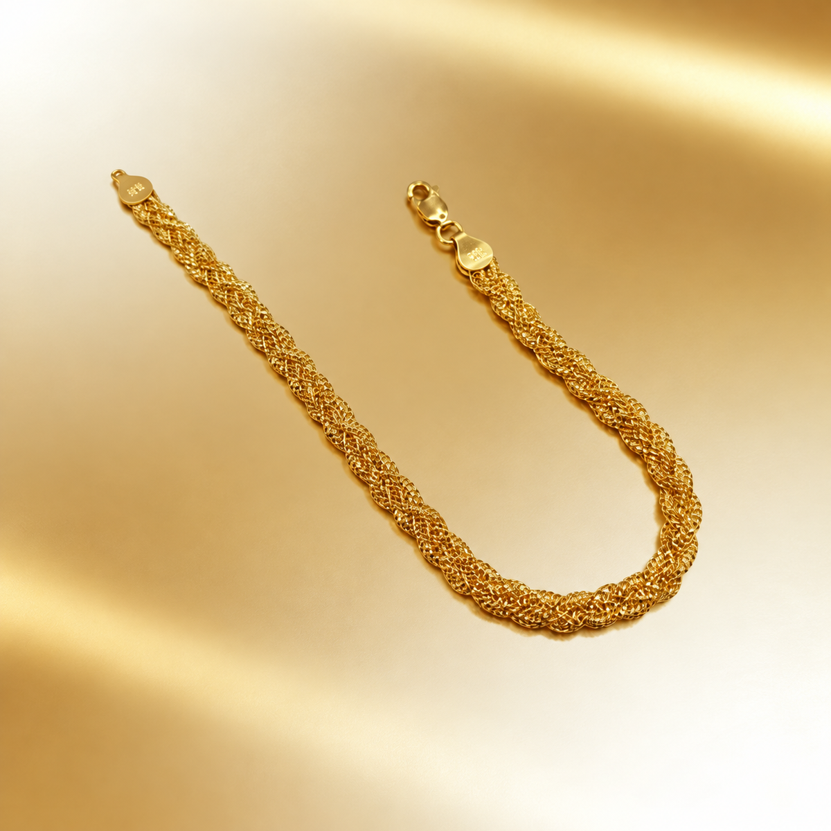 916 gold Wave Braided Bracelet in a U shape on a warm gold background with clasp and end caps visible