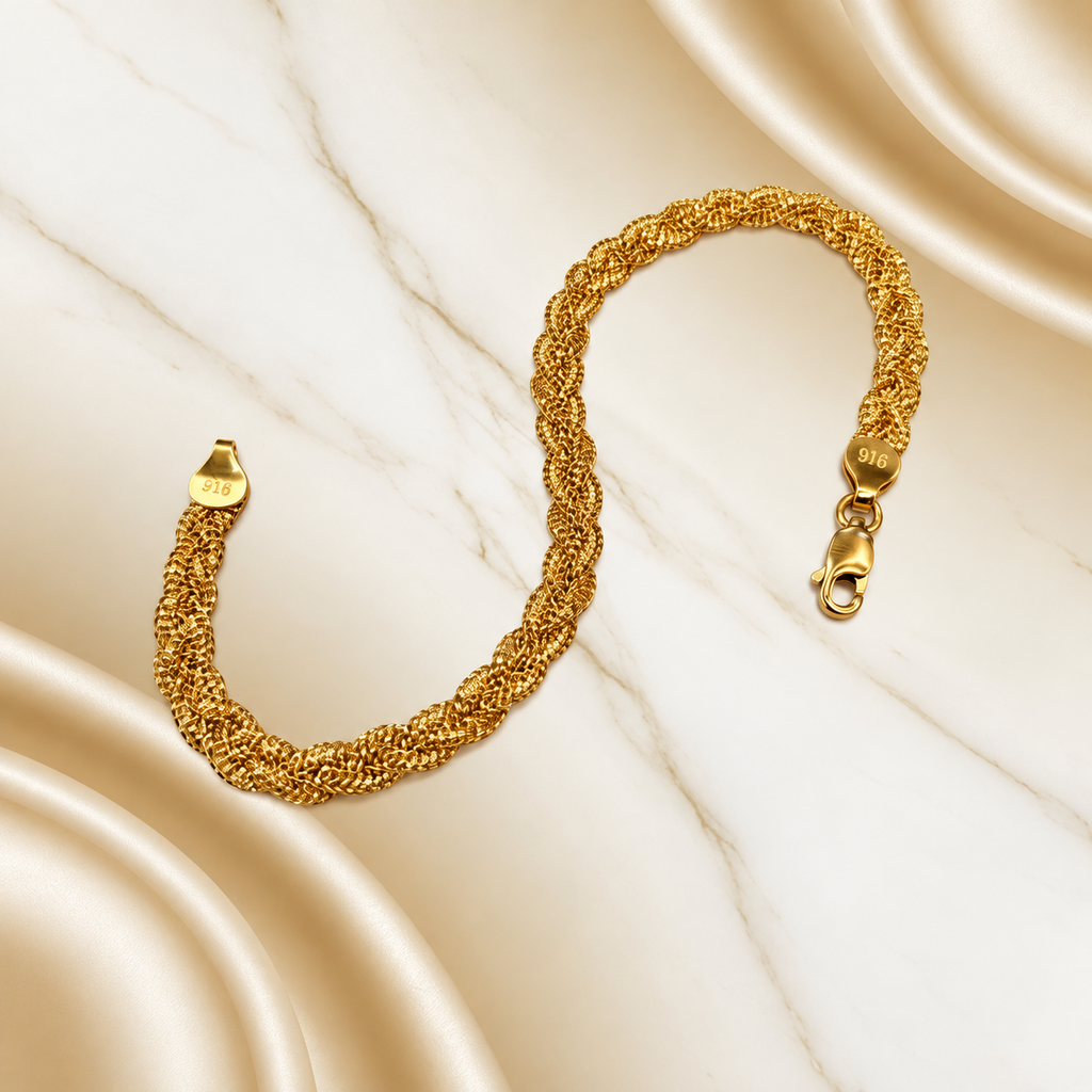 BR22589 916 gold Wave Braided Bracelet in an S shape on marble with lobster clasp and physical 916 stamps