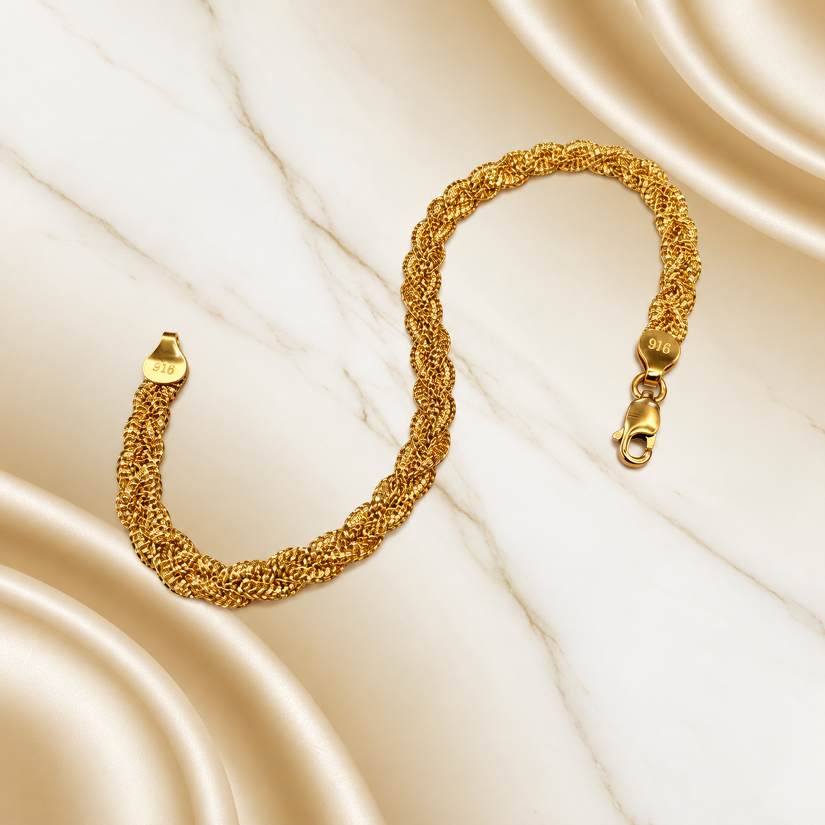 BR22589 916 gold Wave Braided Bracelet in an S shape on marble with lobster clasp and physical 916 stamps