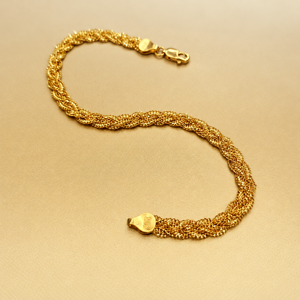 BR21402 916 gold Wave Braided Bracelet in an S shape on gold fabric with clasp and stamped end cap