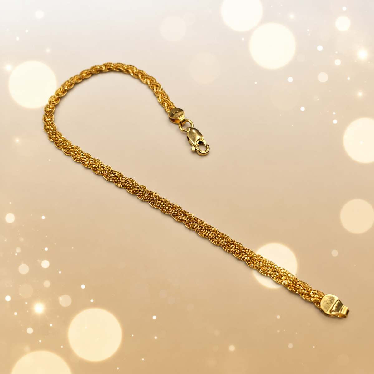 BR22587 916 gold Wave Braided Bracelet extended over a soft gold bokeh background with clasp visible