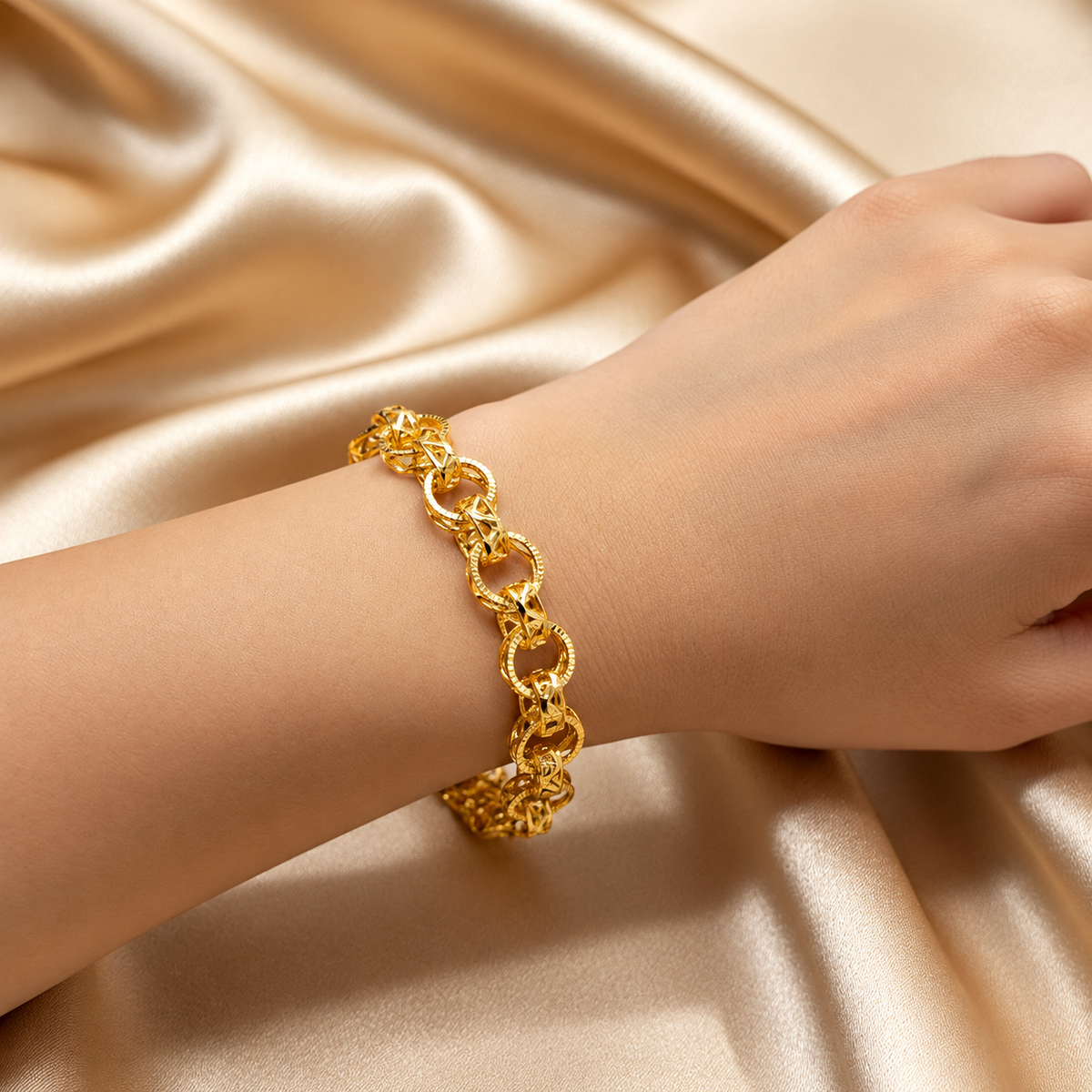 916 gold Wave WW Design Bracelet worn on a wrist against cream satin, shown as a styling reference