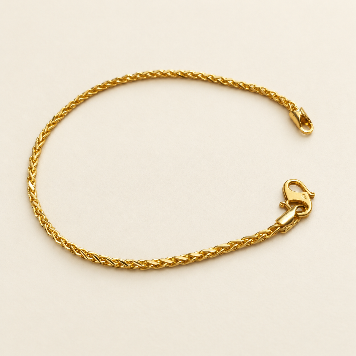22K / 916 gold Spike Bracelet, full view showing polished diagonal links and lobster clasp on ivory